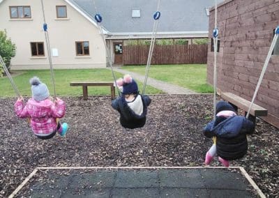 Swing set kids playing at Mellowes outdoor adventure centre and playground