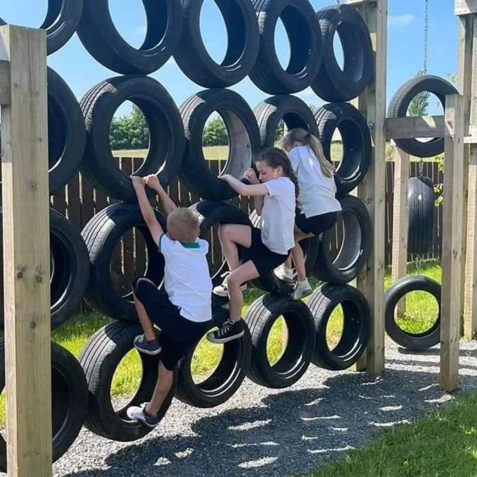 Fun on the Tyre wall kids playing outdoors at Mellowes Adventure Centre